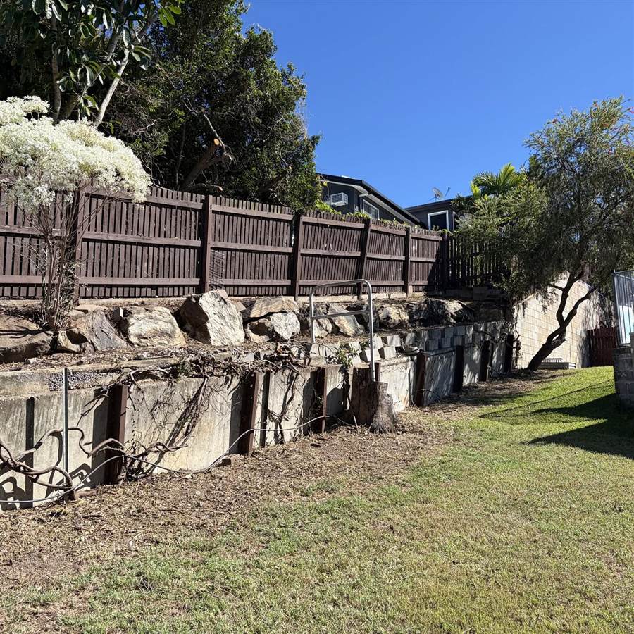 The same bank cleared back to bare ground, exposing the stone and timber retaining walls.